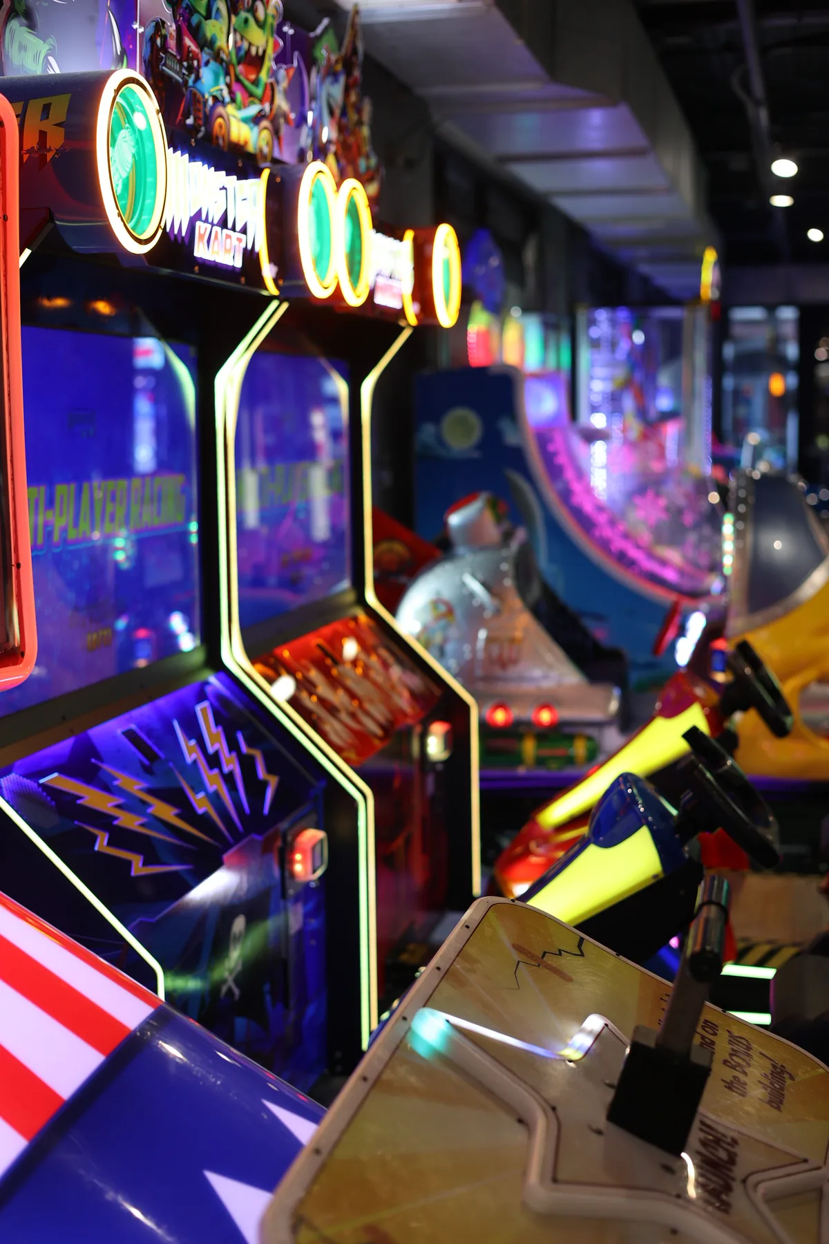 A lit row of arcade cabinets running down the floor