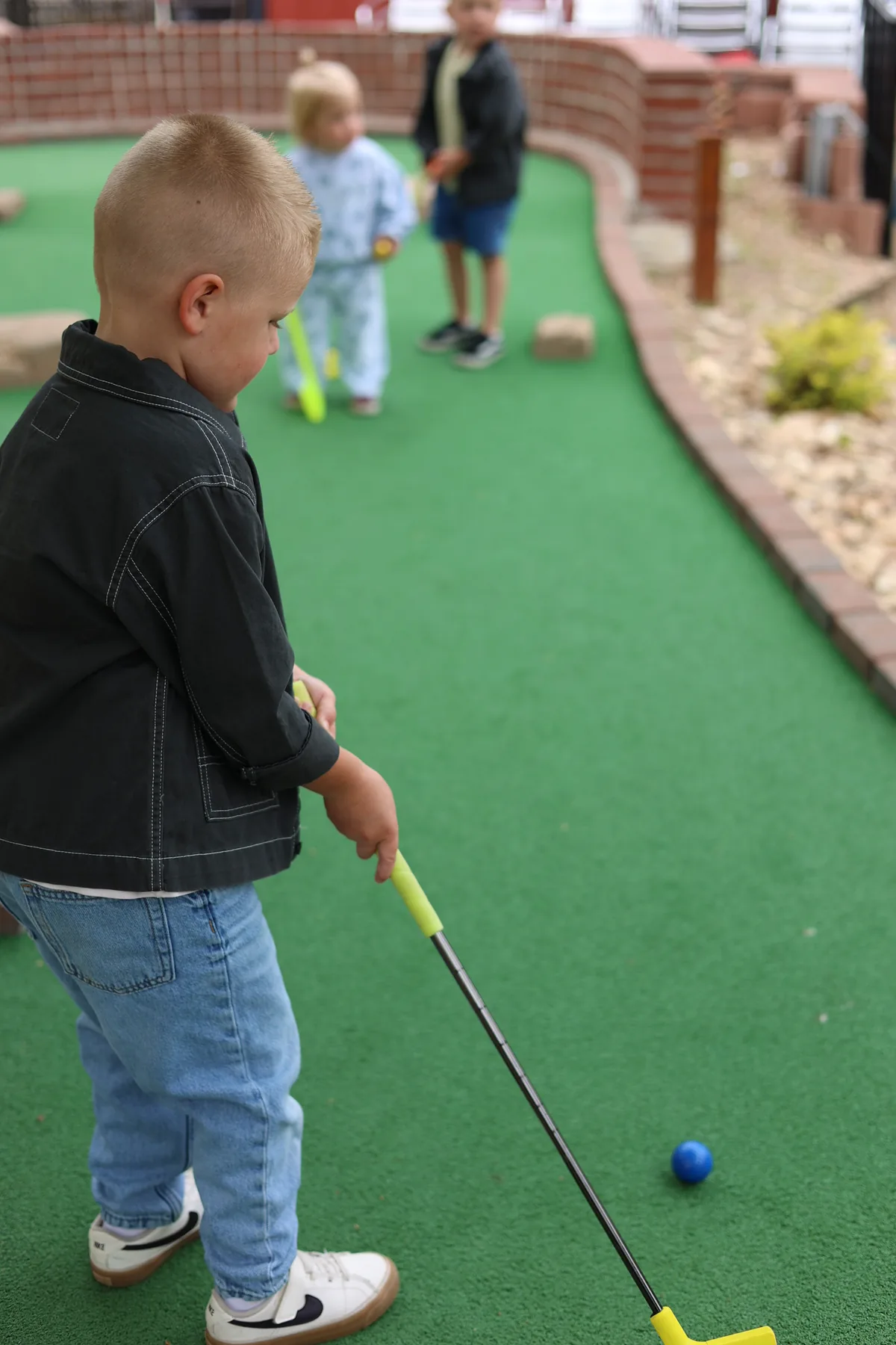 Young players putting on the green