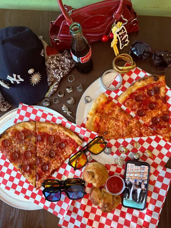 A pepperoni pizza on the patio table