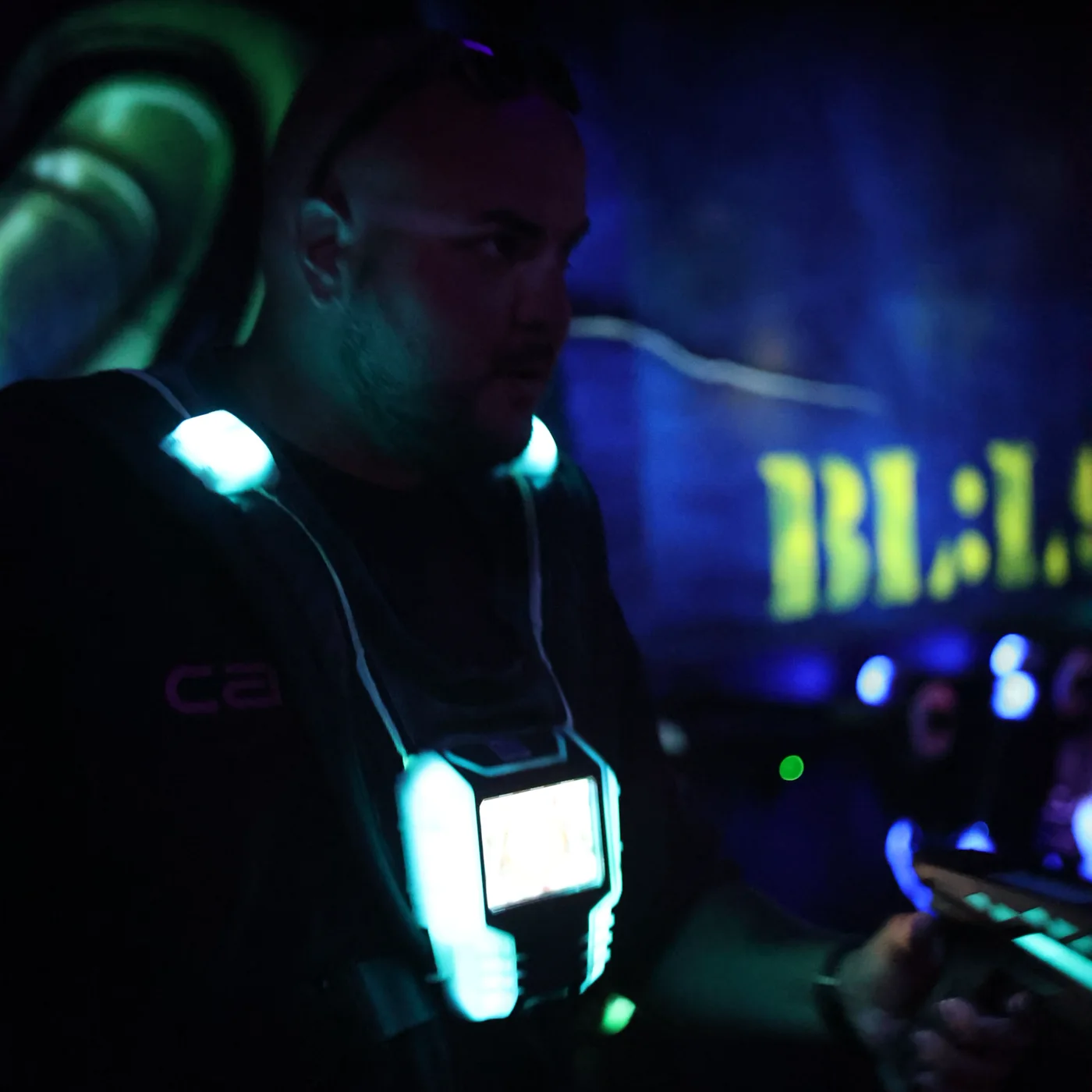 A vest and marker lit up in the dark arena