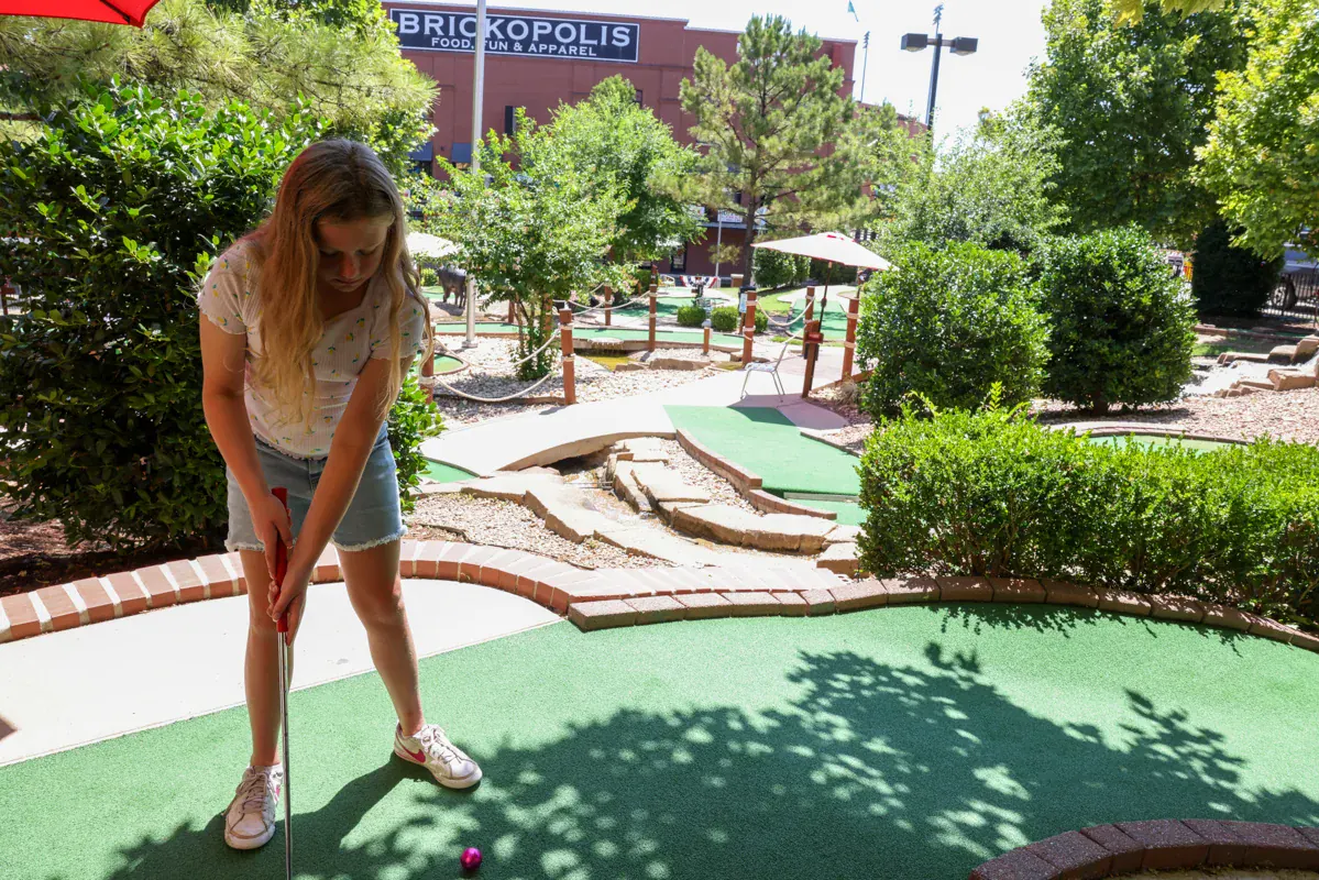 A player on the canal-side mini golf course